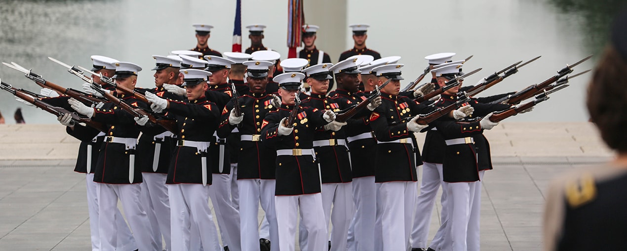 Marine Corps drill team performing at ceremony
